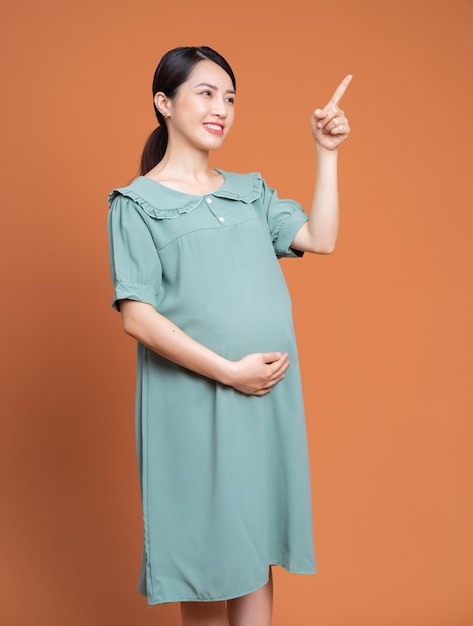 Photo of Asian pregnant woman on background