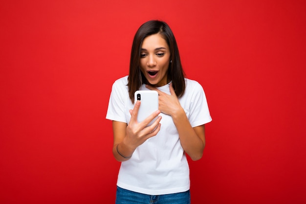 Photo of attractive crazy amazed surprised young woman wearing casual stylish clothes standing