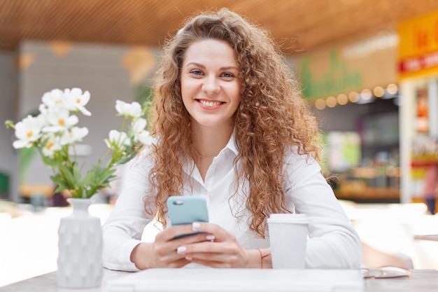 Photo of attractive curly woman with smile