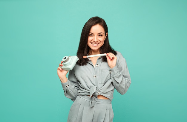 Photo of attractive lady holds camera and smiles