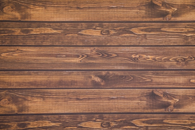 Photo of Background from wooden planks to dark charred aged wood, lying horizontally. Empty copy space.