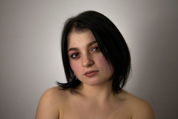 Photo of a beautiful young woman on a gray background