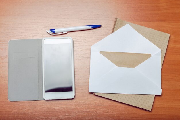 Photo of blank envelope on a  wooden surface 