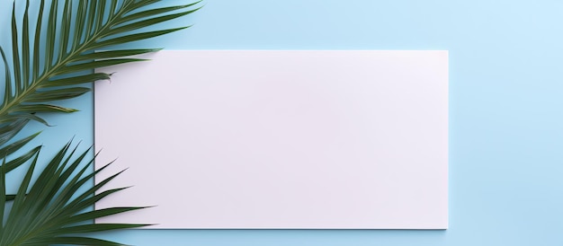 Photo of a blank paper with a palm leaf on a blue background with copy space