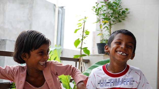 Photo of brother and sister laughing out loud