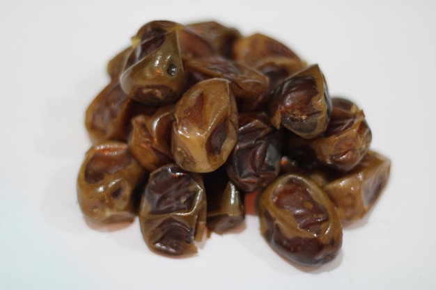 Photo of brown dates with a white background