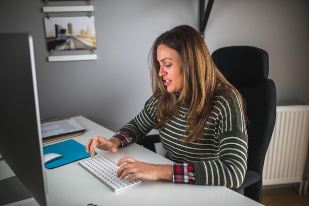 Photo of a businesswoman working on a computer in the home office