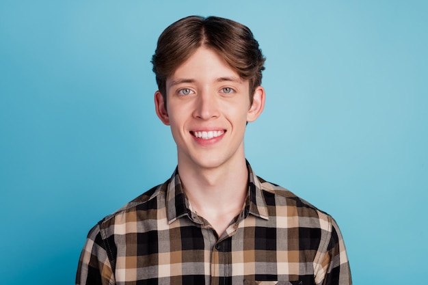 Photo of cheerful young guy happy positive smile fun toothy smile veneers stomatology isolated on blue color background