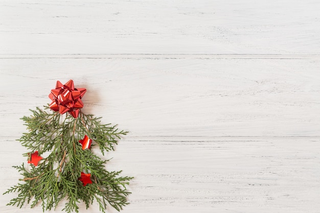 Photo of Christmas tree on the white wooden background with copy space.