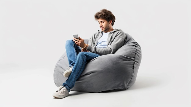 Photo of a Clever Man in Casual Attire Engrossed in His Smartphone on a Bean Bag