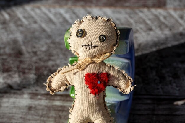 Photo photo of creepy voodoo doll on wooden floor