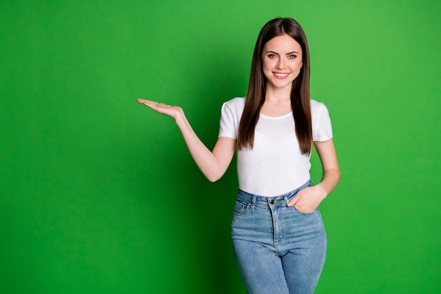 Photo of cute charming woman wear casual outfit pointing one arm empty space isolated green color background