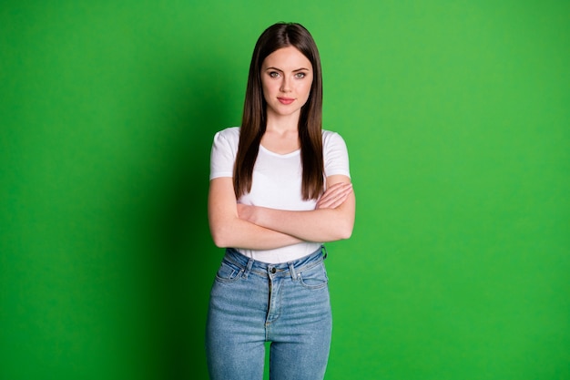 Photo of cute confident woman dressed casual outfit arms folded isolated green color background