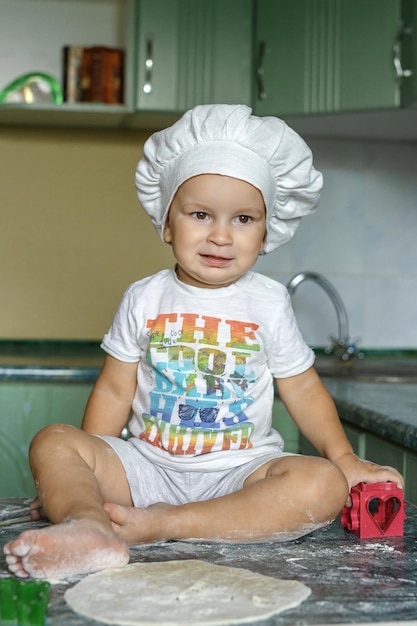 photo of cute little baby with chef hat