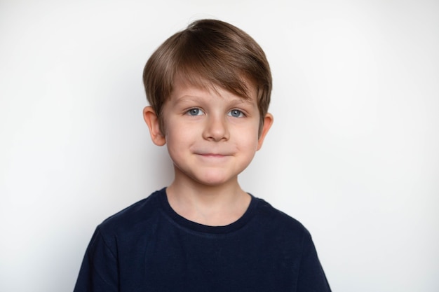 Photo of cute young happy boy in dark t-shirt