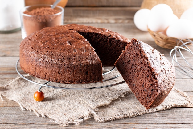 Photo of delicious chocolate sponge cake on wooden table