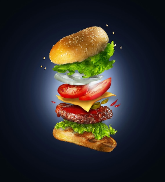 Photo delicious grilled beef burger with flying ingredients isolated on yellow background