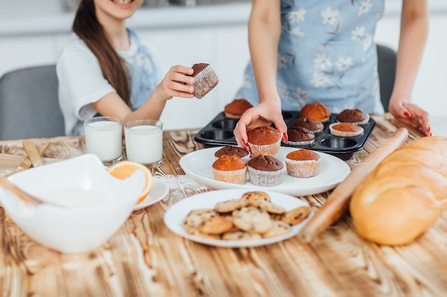 Photo of family cook cupccakes and cookie together