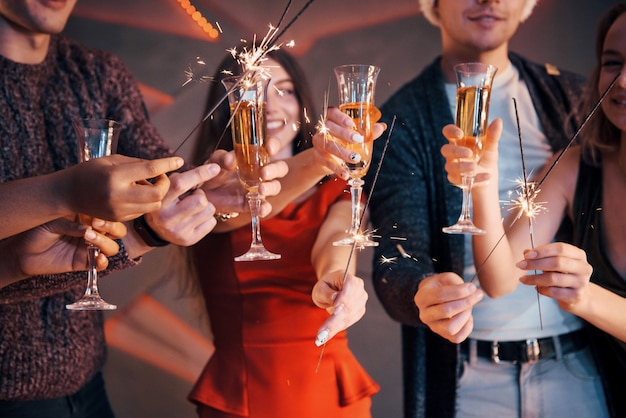 A photo featuring a group of friends who have fun with snowmen and champagne. Happy New Year. Close up.