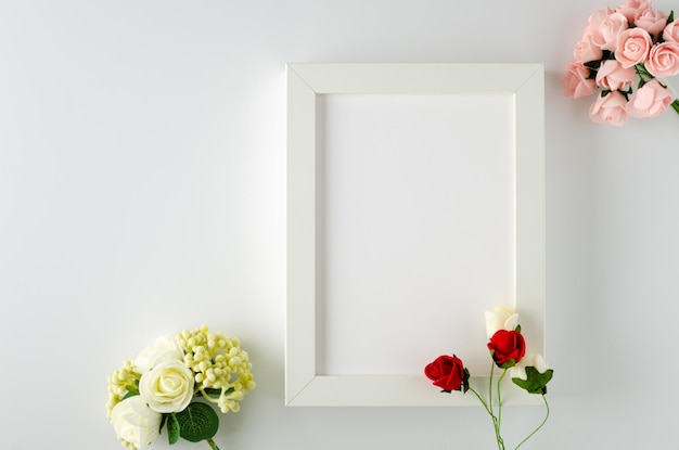 Photo frame with red and white roses on white background