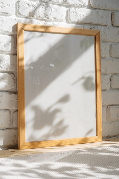 Photo frames on floor over white brick wall