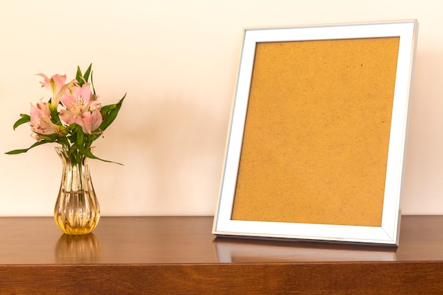 Photo frames and flower vases on the table