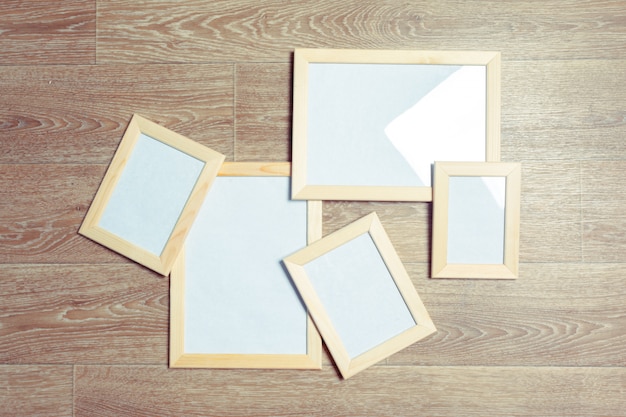 photo frames on the wooden wall