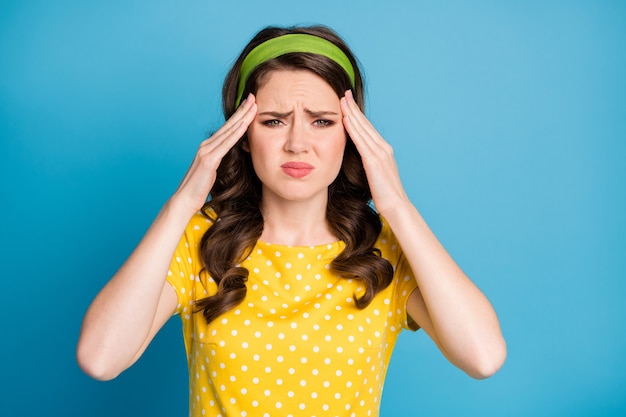 Photo of frustrated girl suffer headache touch finger forehead isolated over blue color background