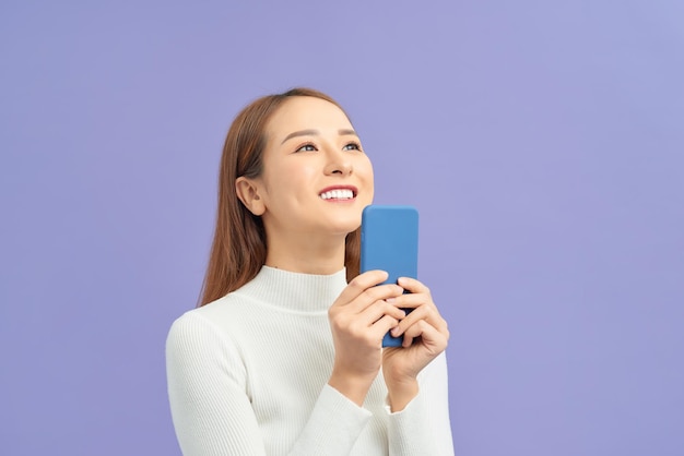 Photo of funny funky lady using her interesting digital gadget isolated violet background