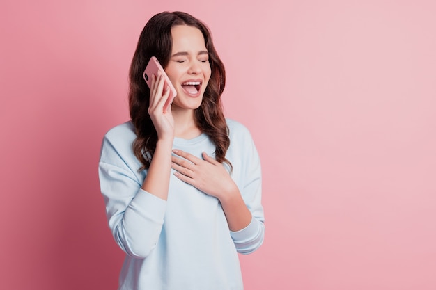 Photo of funny girl use smartphone call laughing out loud