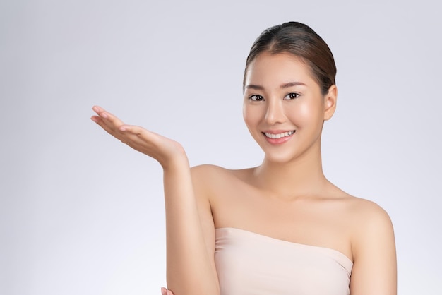 Photo of a gorgeous woman in a concept of empty space for beauty care product