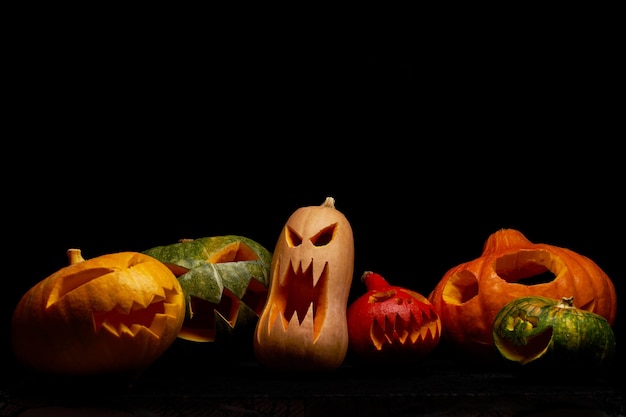 Photo of halloween pumpkins on empty black background