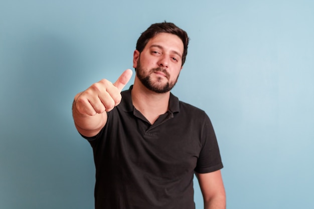 Photo of handsome man in smiling on camera with thumb up