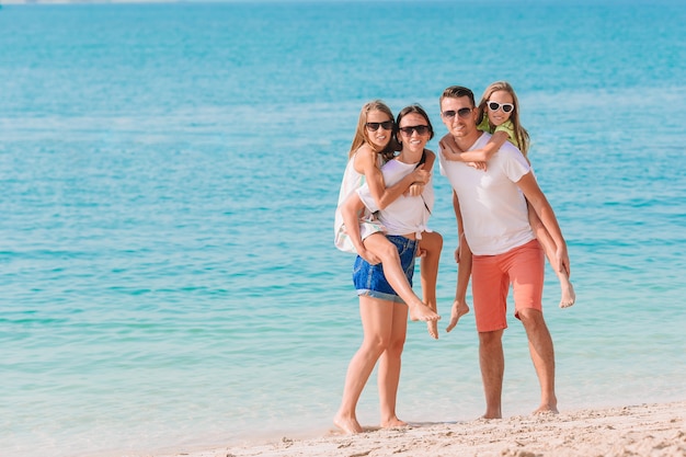 Photo of happy family having fun on the beach. Summer Lifestyle