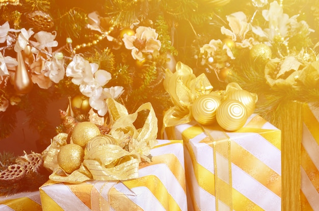 Photo of luxury gift boxes under Christmas tree