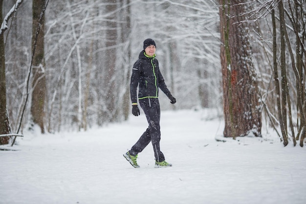 Photo of man in sports clothes on run in winter