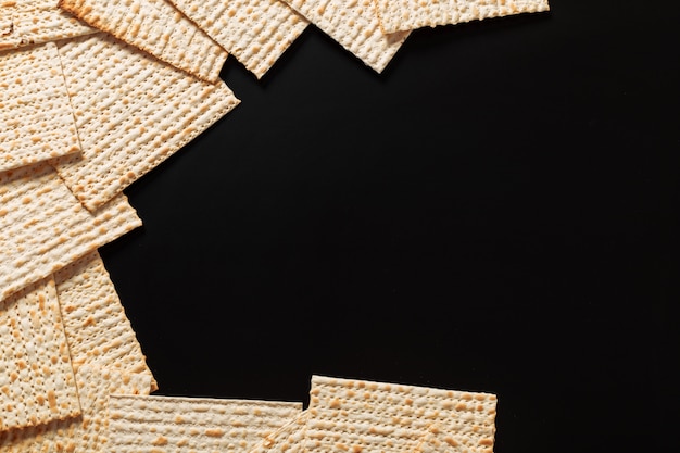 A photo of matzah or matza pieces on black 