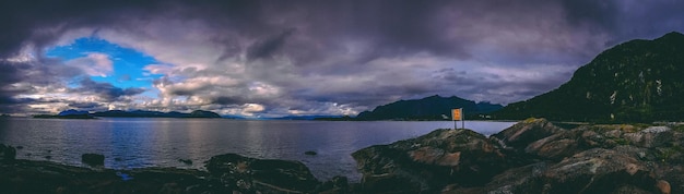 Photo of norway with sea cloudy sky on summer evening