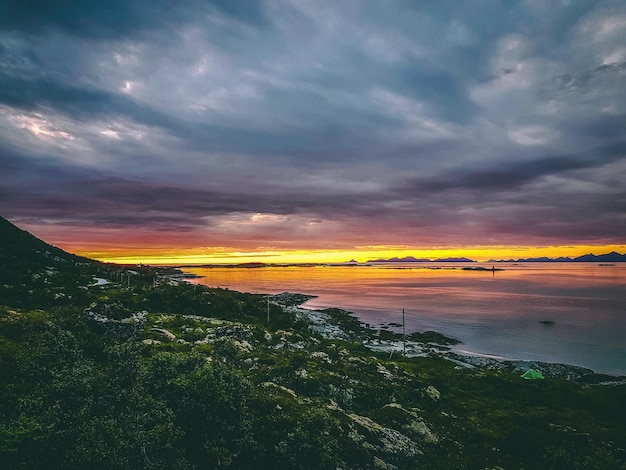 Photo of Norway with sea hill with cloudy sky on summer at sunset