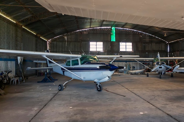 Photo of old angar with several airplanes ready for flight