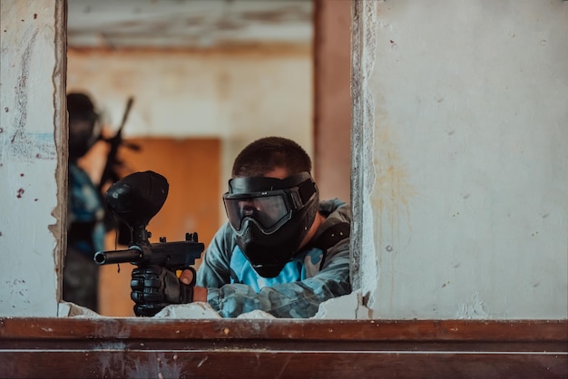 Photo of a paintball team in action with professional equipmentselective focus