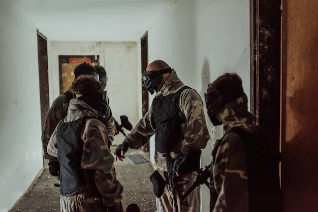 Photo of a paintball team in action with professional equipmentselective focus