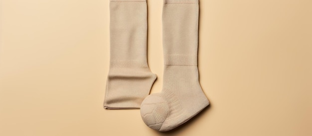 Photo of a pair of white socks hanging on a wall with plenty of copy space with copy space