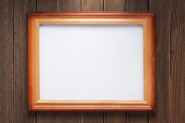 Photo picture frame on wooden background wall