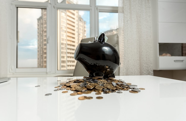 Photo of piggy bank on office table against city view