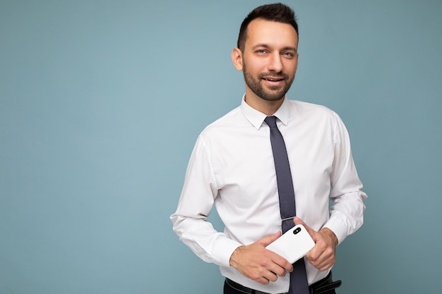 Photo of positive handsome good looking brunet unshaven man with beard wearing casual white shirt