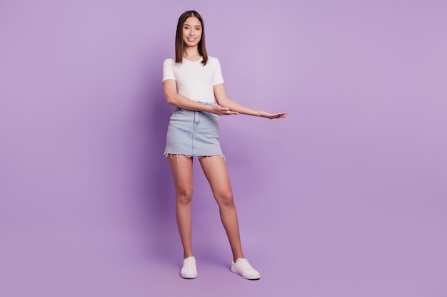 Photo of positive promoter lady hands demonstrate empty blank space on violet background