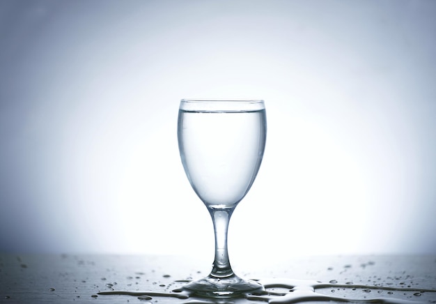 Photo of pouring water into a glass of water