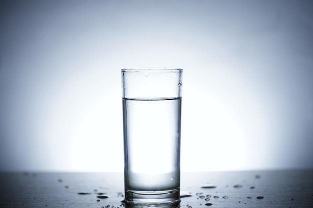 Photo of pouring water into a glass of water