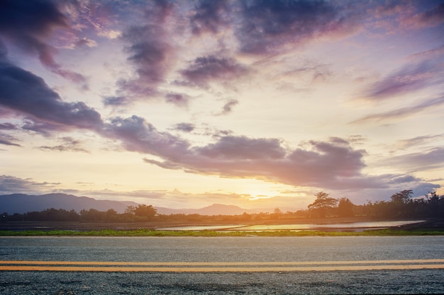 A photo of the road with sunset. landscape in the summer time in Thailand